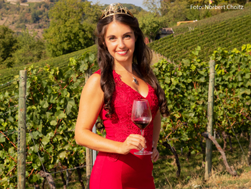 Die Weinprizessin Carolin Hillenbrand hält ein Weinglas in der Hand. 